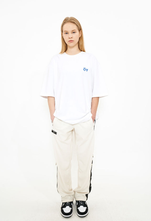 オーワイ(OY)  LOGO TAPE RING TRACK PANTS-CREAM