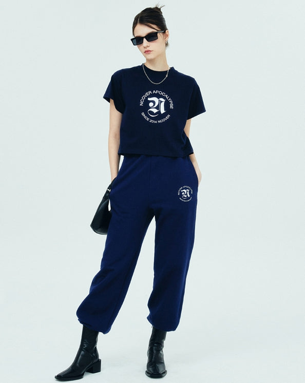 NCOVER（エンカバー）ROMAN TYPO LOGO TRAINING PANTS-NAVY